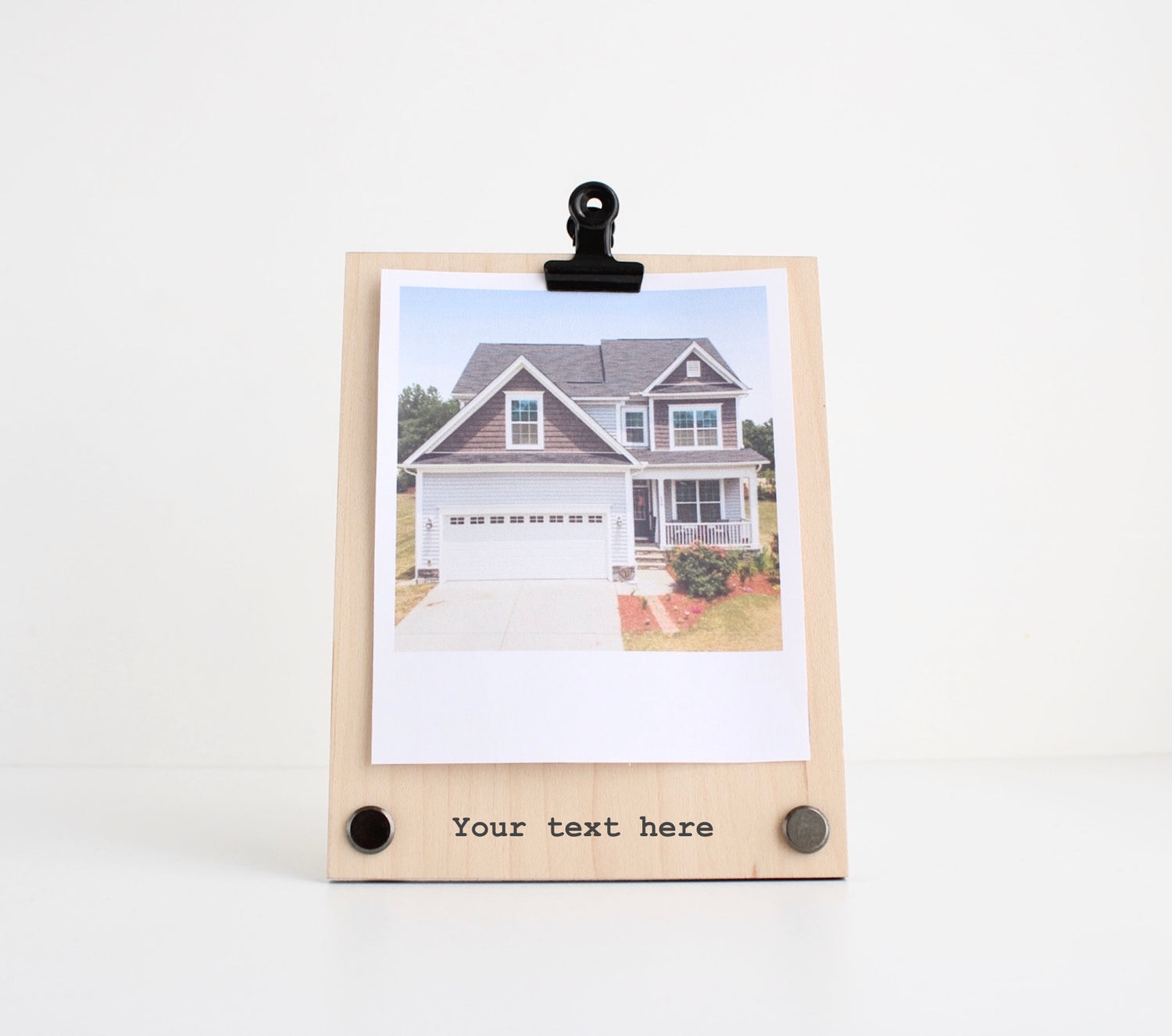 Single layer maple veneer frame with black clip at the top holding photograph